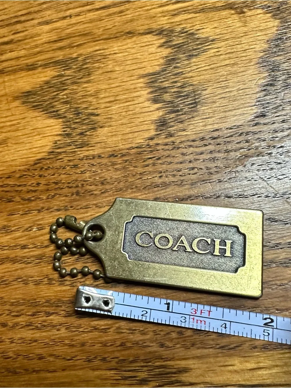 Coach brass tag
